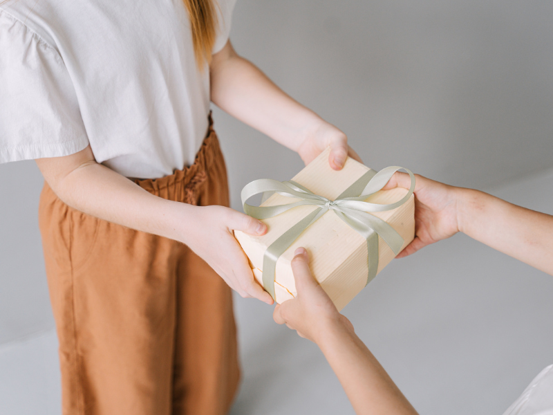 woman be handed her Housewarming Gift