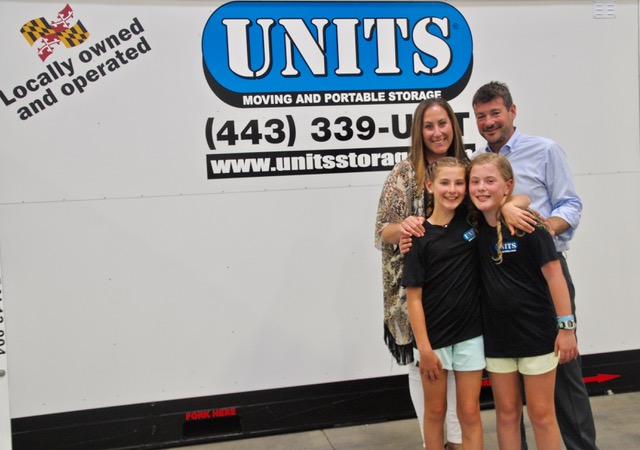Happy family stands in front of their UNITS Portable Storage Container in Baltimore Maryland