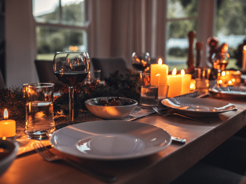 A table table that has been set for dinner with candles.