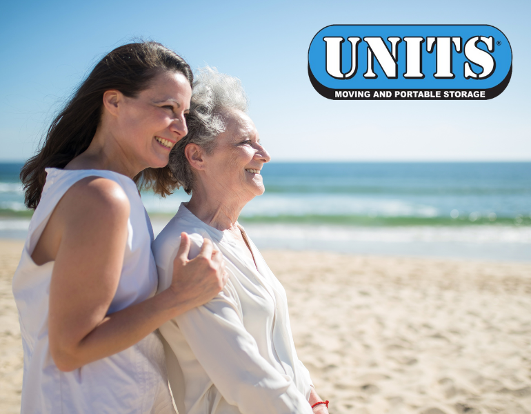 An older woman and younger woman on the beach with UNITS logo