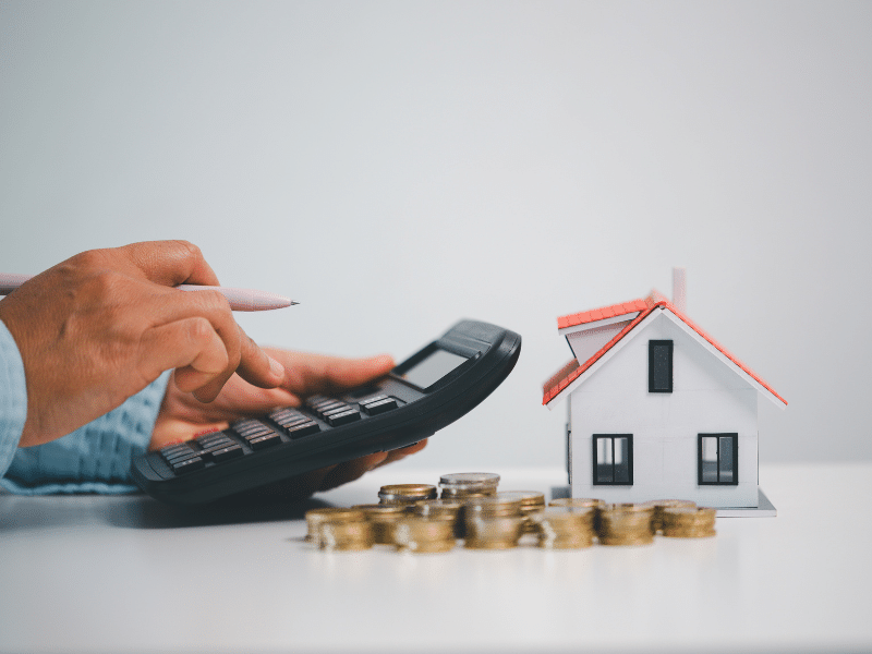 person calculating the financial implications of moving into a new home