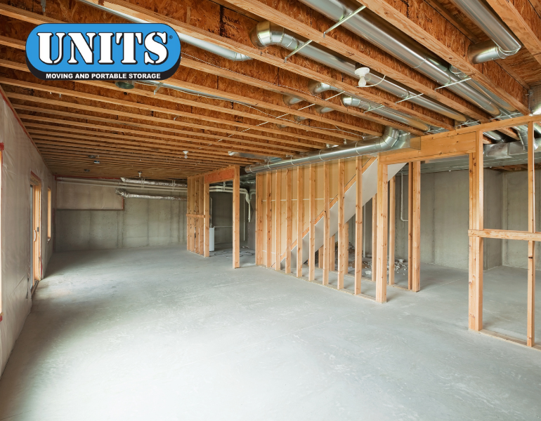 a pic of a basement being remodeled with units logo