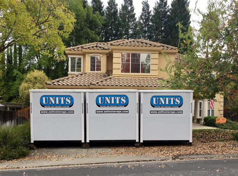Three UNITS Moving and Portable Storage of Charlotte containers in front of a house.