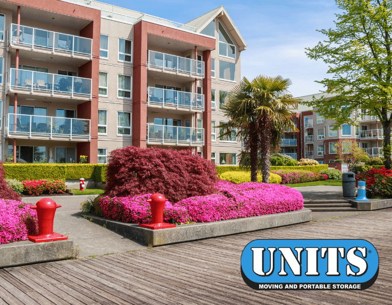 Apartment complex with beautiful landscape, with UNITS Moving and Portable Storage of Charlotte logo.