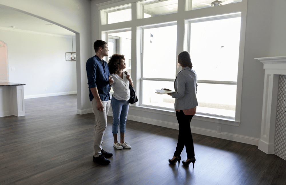 Couple meeting with a realtor to look at a house.