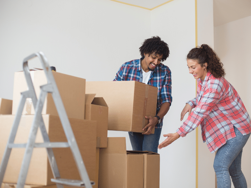 A couple unpacking boxes in their new home.