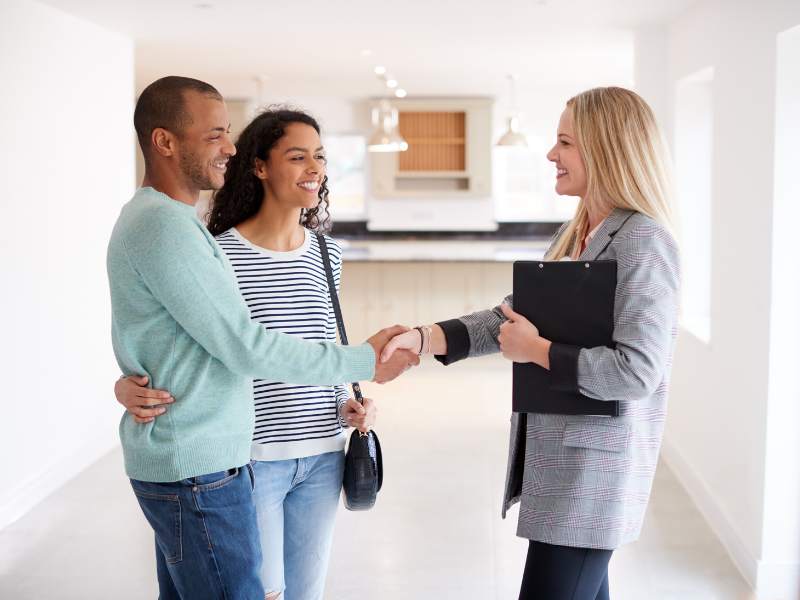 Realtor shaking hands with a couple