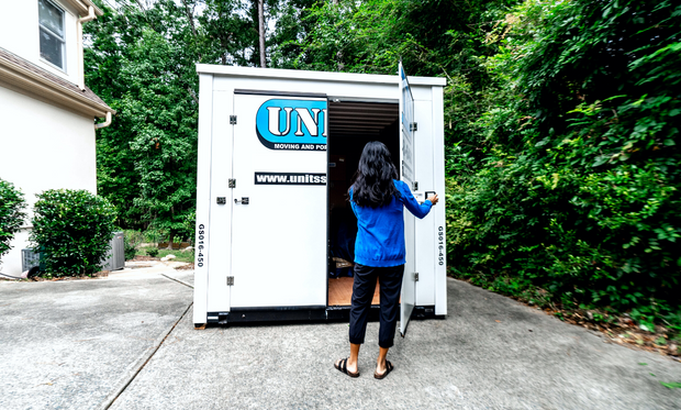 Woman opening up a UNITS Moving and Portable Storage Container.