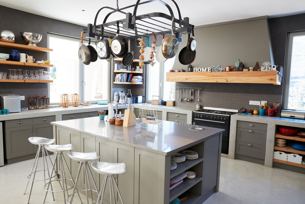 A kitchen than is clean and decorated with gray walls.