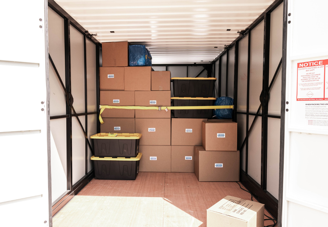 UNITS Moving and Portable Storage Container filled with cardboard boxes and plastic containers.
