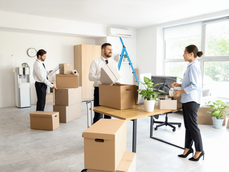 people following commercial moving tips for spring relocation. loading stuff into portable storage containers