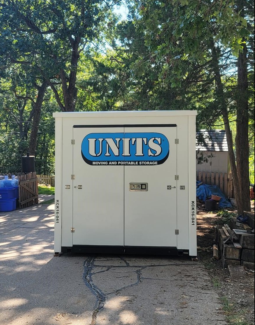 A Units of Kansas City container sitting in a driveway.
