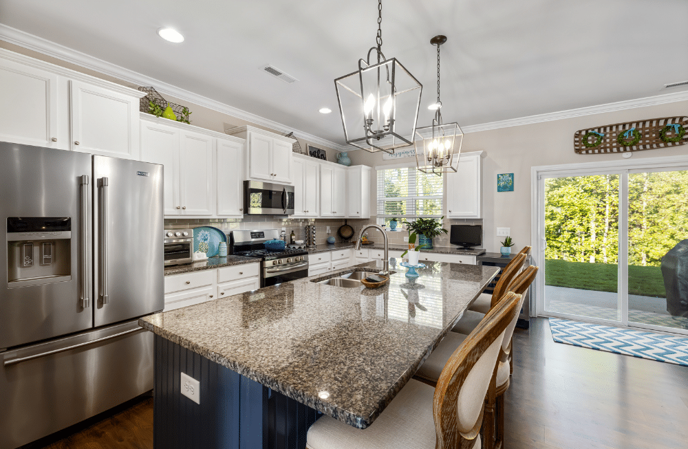 A kitchen that is clean and decorated with white cabinets.