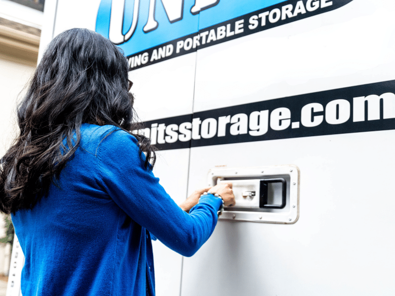 Woman locking her UNITS Moving and Portable Storage container.