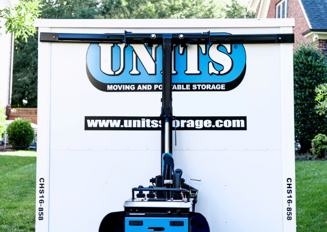 A Units Of Louisville container sitting in front of a house.