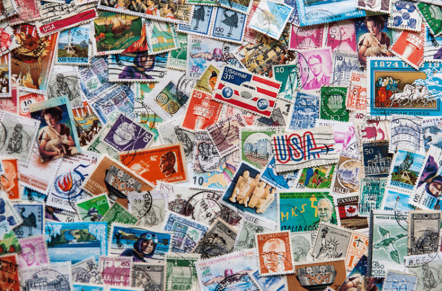 Lots of stamps scattered on a table.
