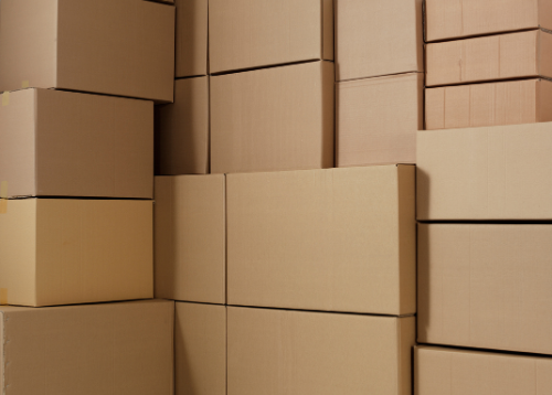 Carboard moving boxes stacked on top of each other.