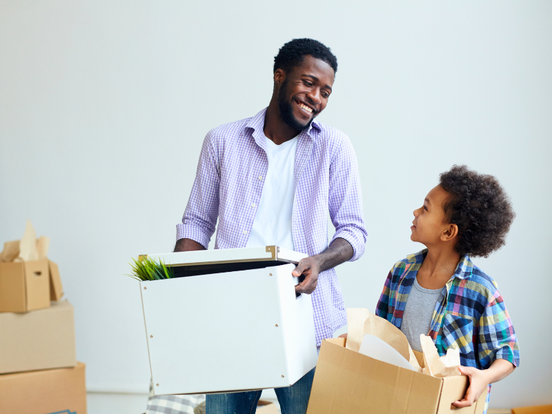 father and son unpacking after a move