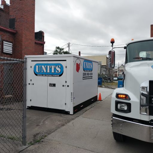 A Units Of Northeast Ohio container sitting on the ground.