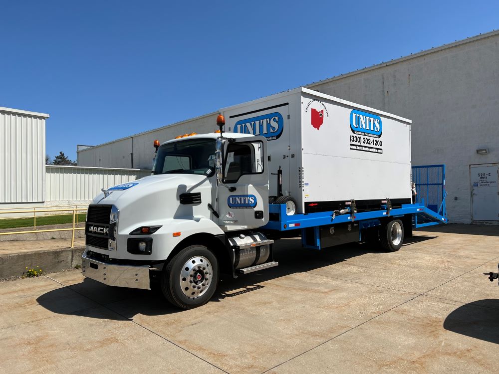 A Units Of Northeast Ohio truck parked behind a warehouse.