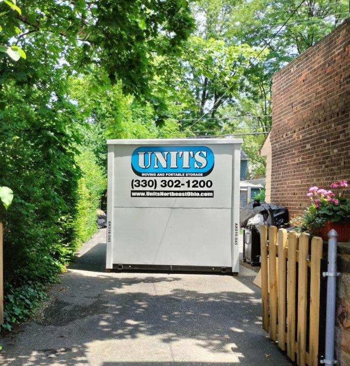 A Units Of Northeast Ohio container sitting in a driveway.