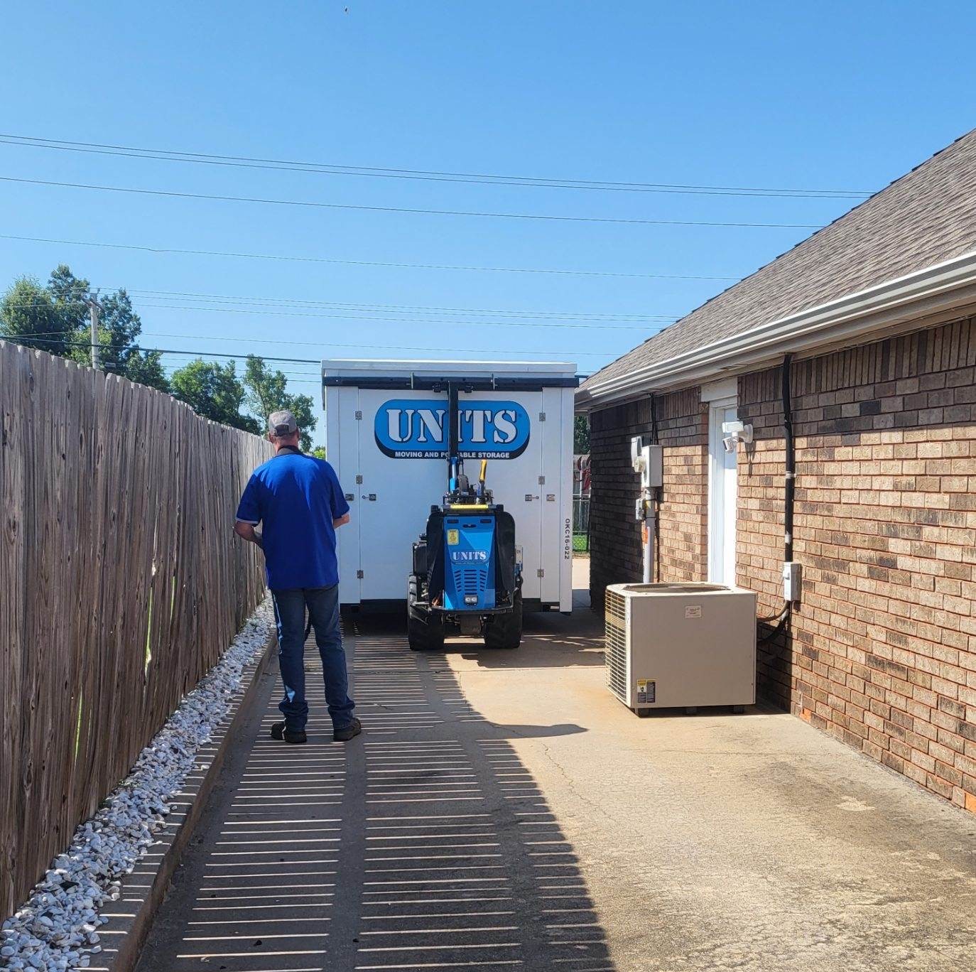 A Units of Oklahoma City container sitting in a driveway.