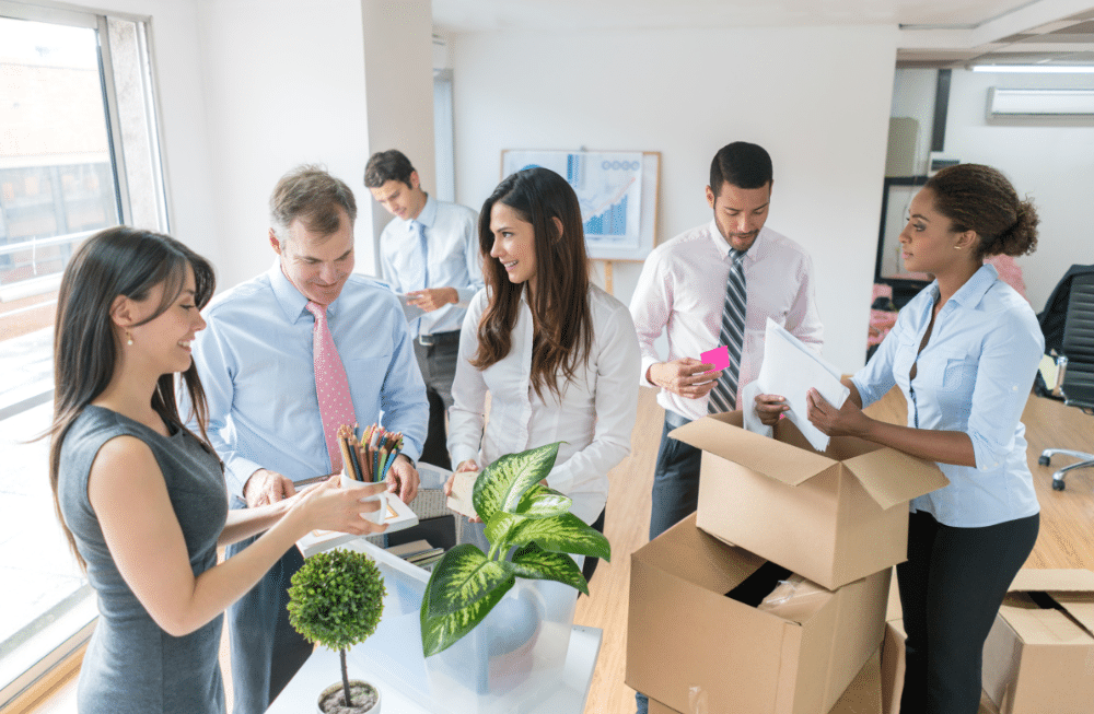 A group of people in a office helping pack to relocate.