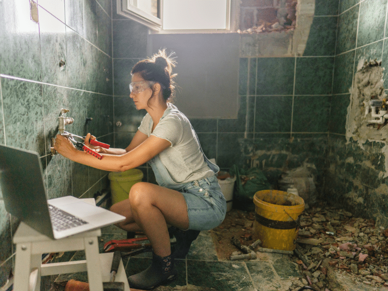 Woman renovating a bathroom.