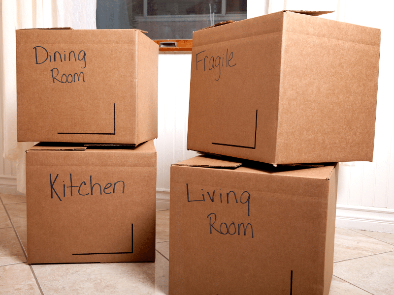 Cardboard boxes labeled dining room, fragile, kitchen and living room.