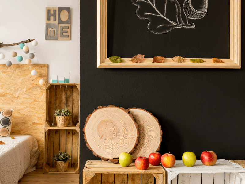 Fall themed room with apples and wooden decorations.