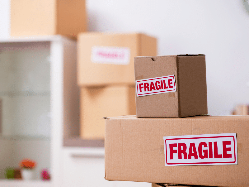 Cardboard boxes stacked on top of each other labeled fragile.