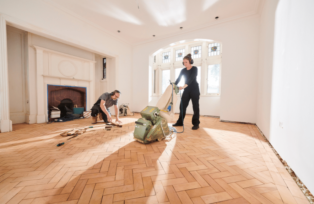 Man and woman repairing their floor tiles.