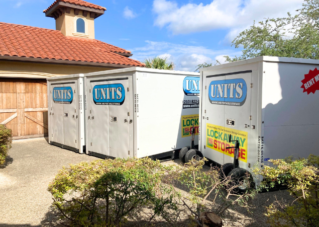 Three UNITS of San Antonio portable storage containers parked on a driveway.