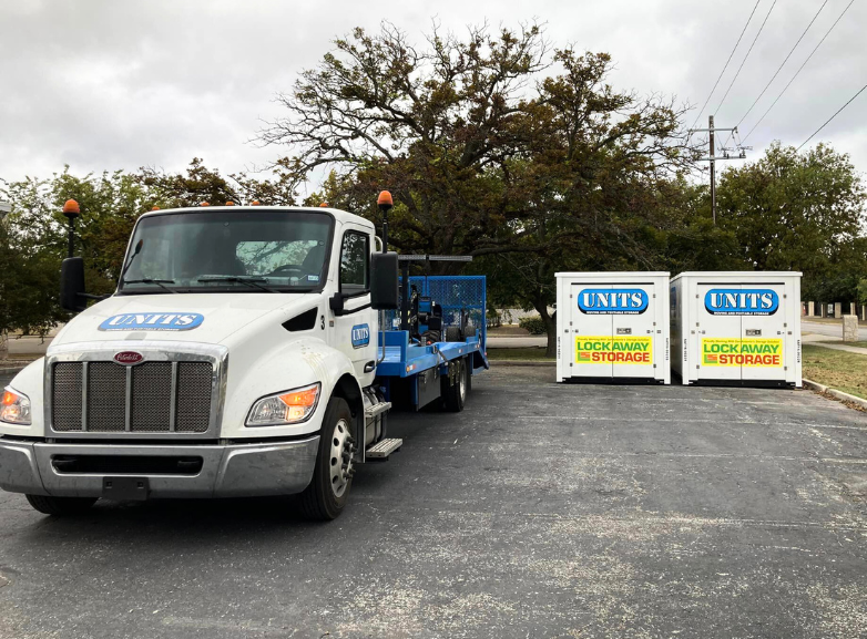 Two UNITS of San Antonio portable storage containers and the delivery truck parked in a driveway.