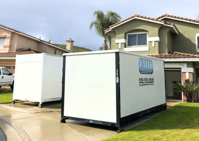 Two UNITS Moving and Portable Storage contianers sitting in a driveway.