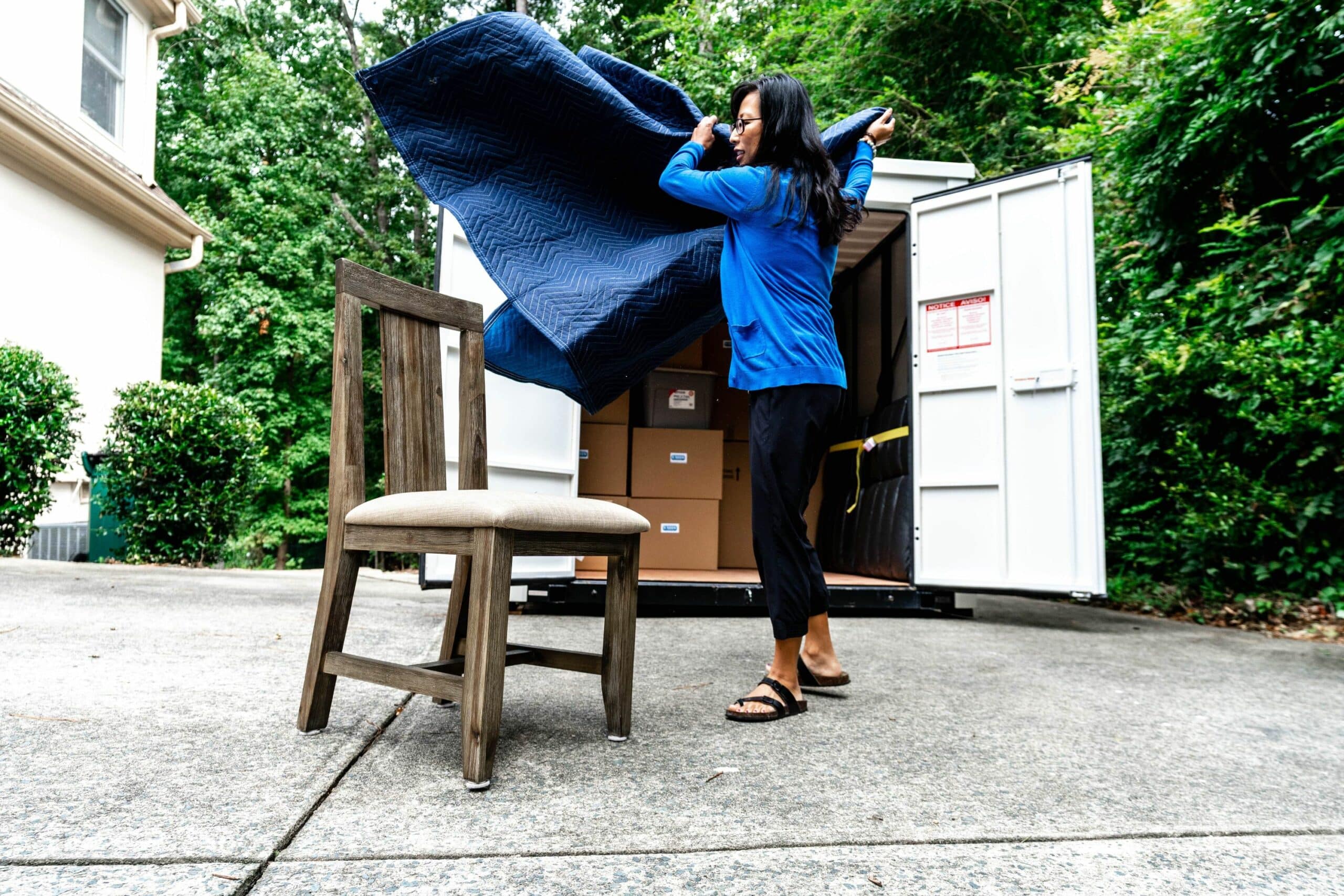 Units of South NJ woman unpacking a storage container.