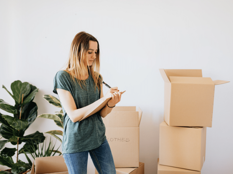 girl following first apartment moving checklist