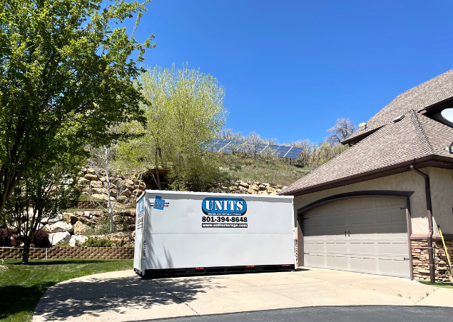 Units Of Utah container sitting in the driveway of a house.