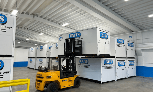 Forklift moving UNITS moving and portable storage containers in a warehouse