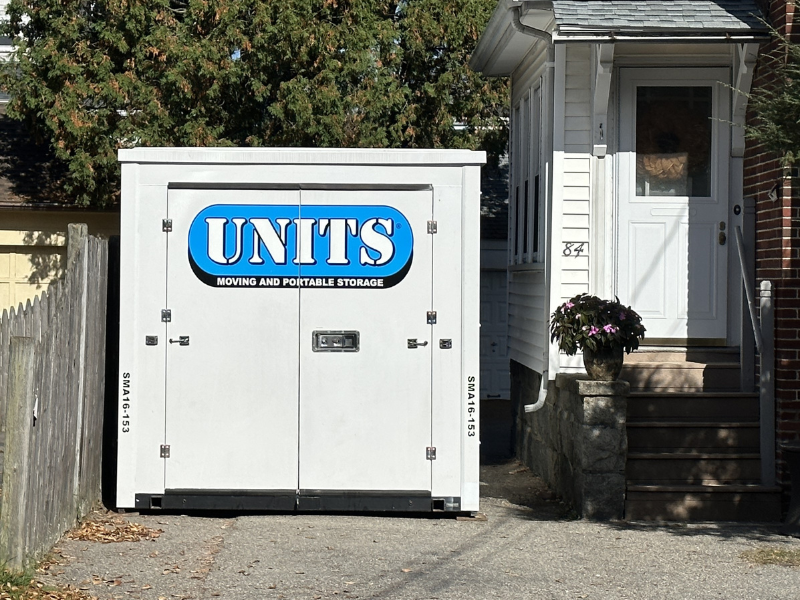 a portable storage container outside a home being used for a summer move