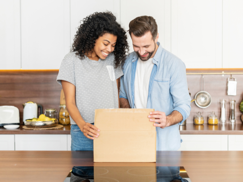 couple opening a gift that was on their housewarming registry list