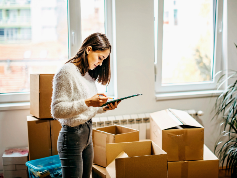 woman going through her Fall Moving Checklist